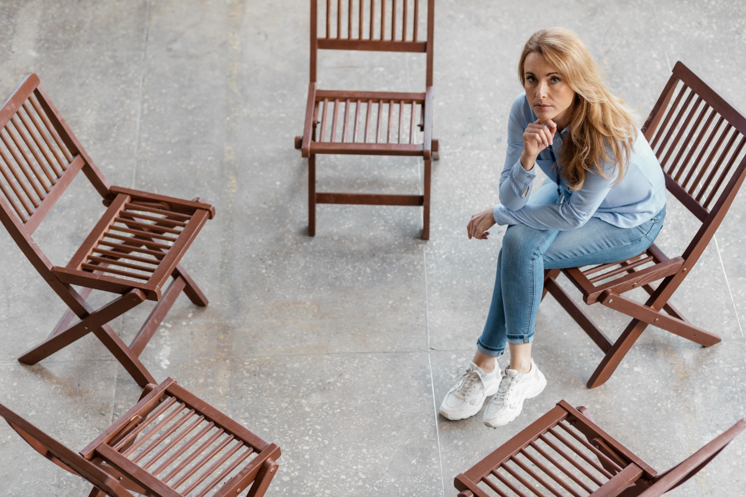 sad woman sitting alone on chair
